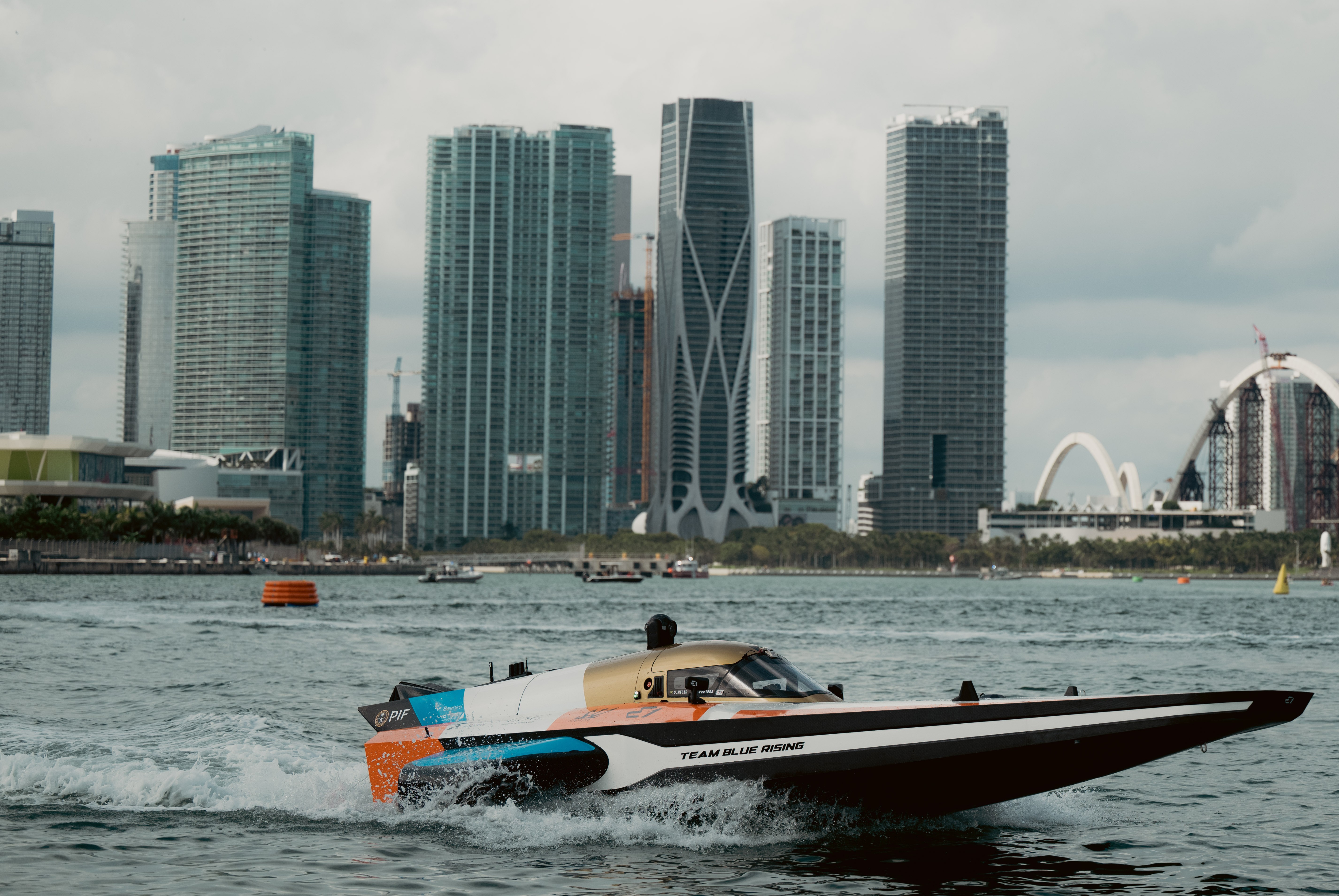 Team Blue Rising RaceBird racing with Miami skyline behind