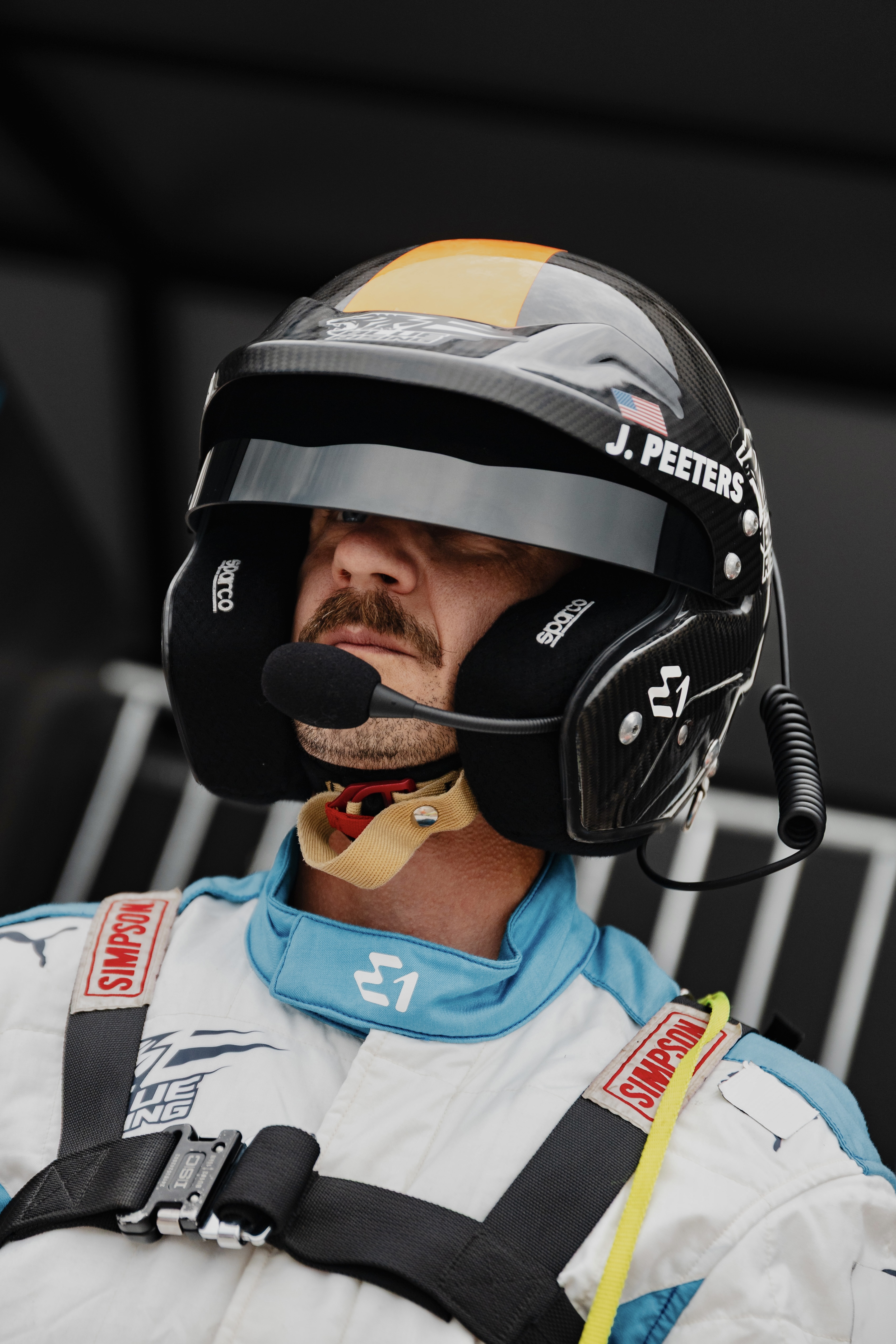 John Peeters in helmet and Team Blue Rising race suit