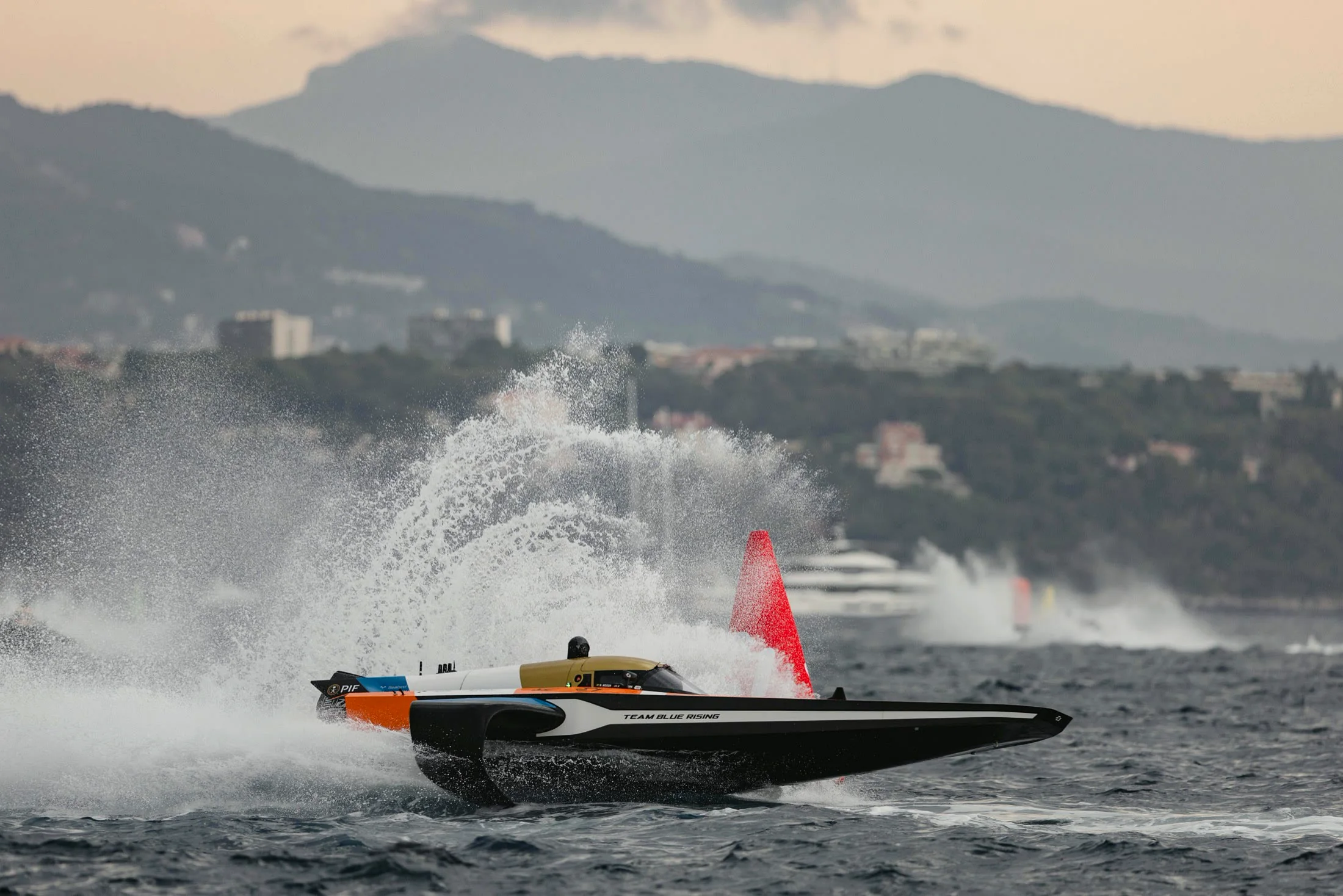 Team Blue Rising RaceBird cutting through spray